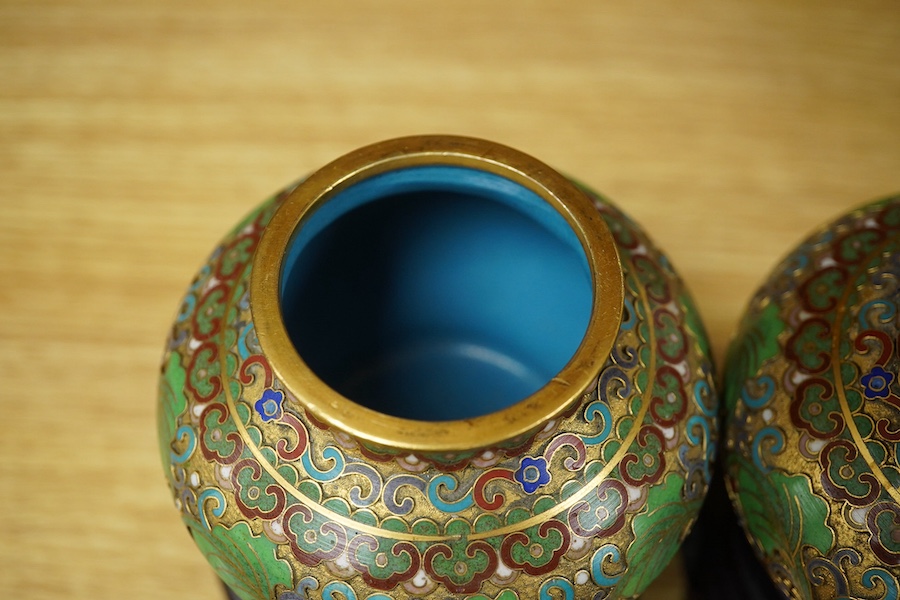 A pair of Chinese cloisonné enamel jars and covers on stands, 14cm high. Condition - good